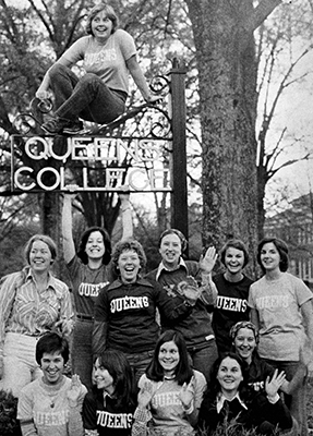 Vintage photo of female students around Queens College sign