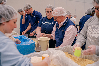 Students and alumni making meals