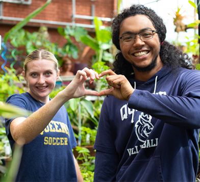 Students making heart shape with hands