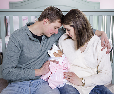 Sydney Dugdale Russell with new baby and husband