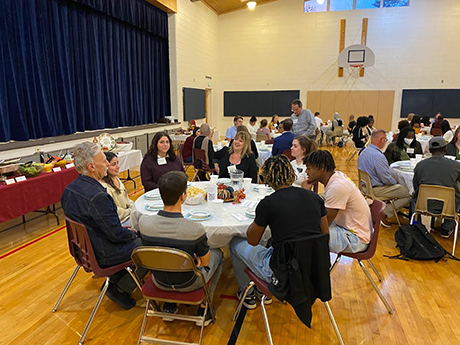 Students talking while seated at tables