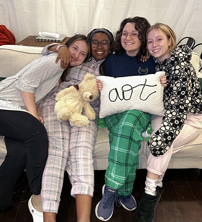 Sisters snuggling on couch