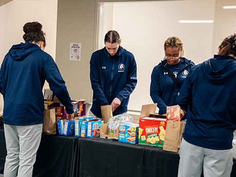 Women's basketball team packing snack bags