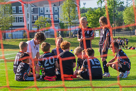 Soccer camp kids in huddle