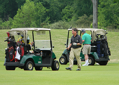 Golfers using golf carts on the fairway
