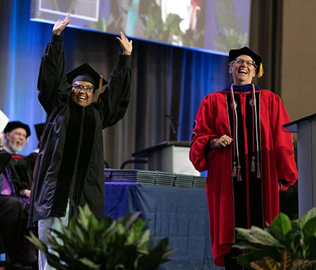 Dr. Clifton waving at family from stage